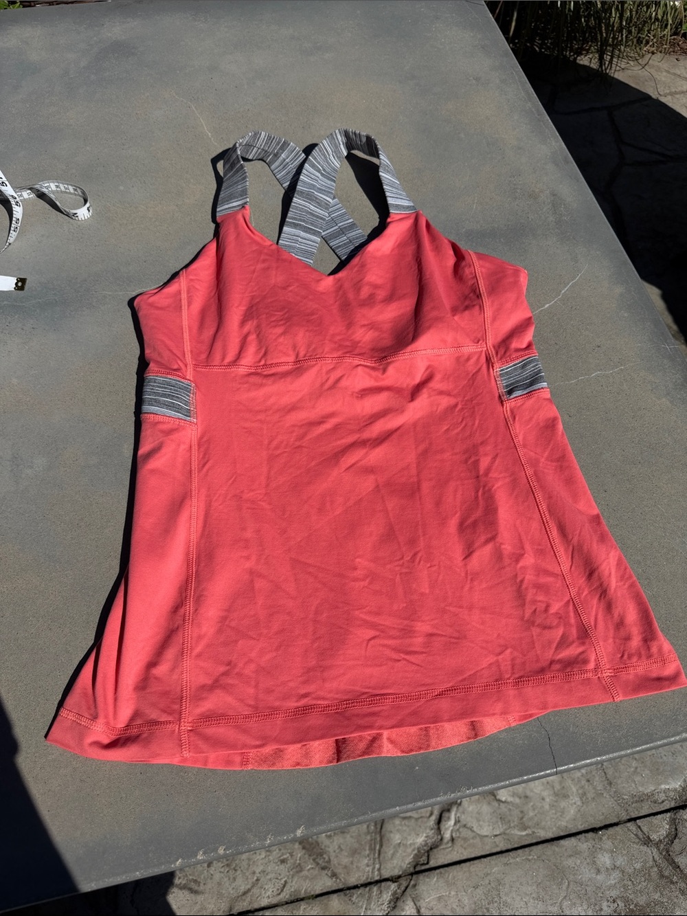 Lululemon Athletica tank in a coral/pink color with gray striped straps